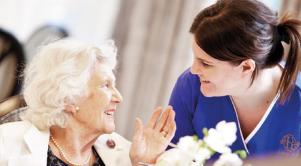 older lady and nurse in care home