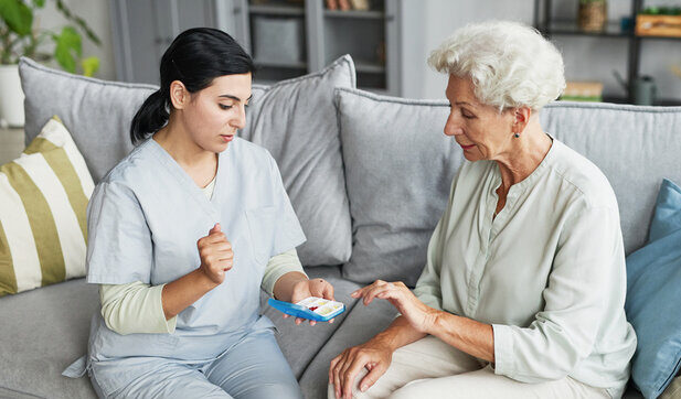 Portrait of female nurse consulting senior woman in retirement home
