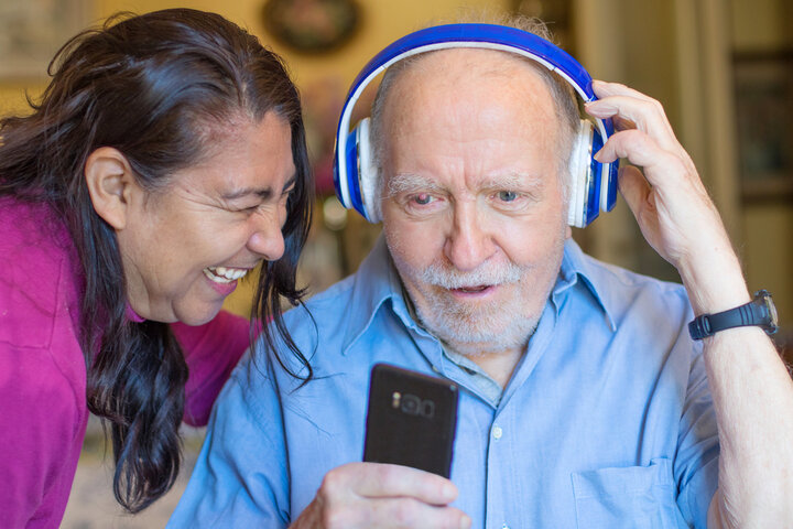 older man with dementia listening to songs