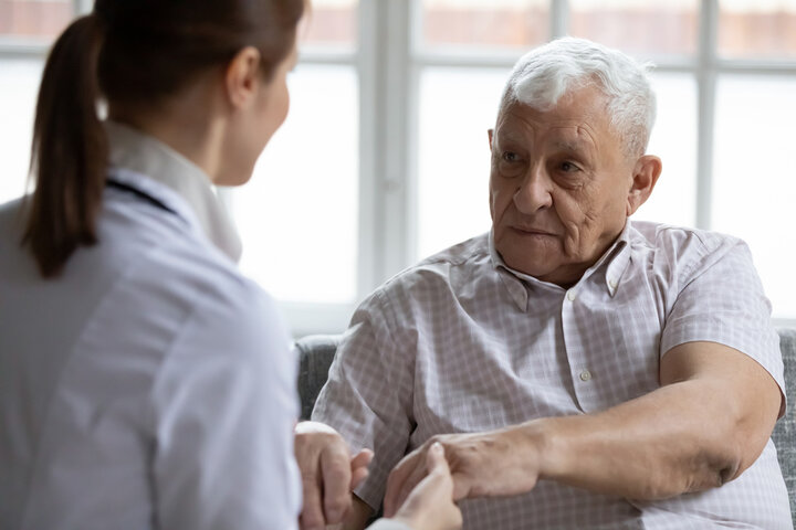 older man in care home with nurse