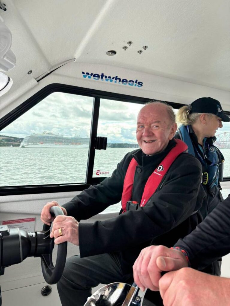 resident smiling on the boat outing at wetwheels
