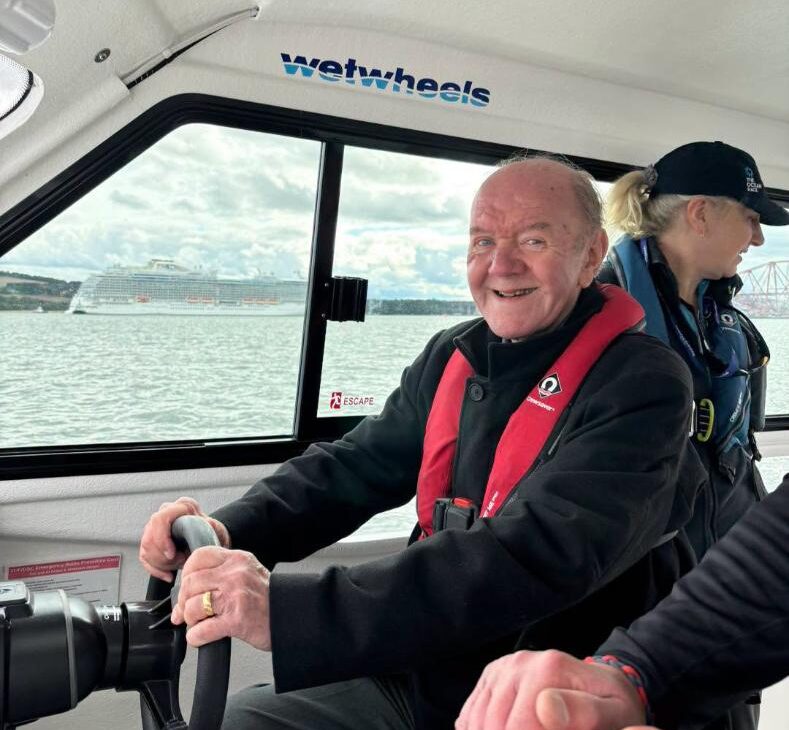 resident smiling on the boat outing at wetwheels